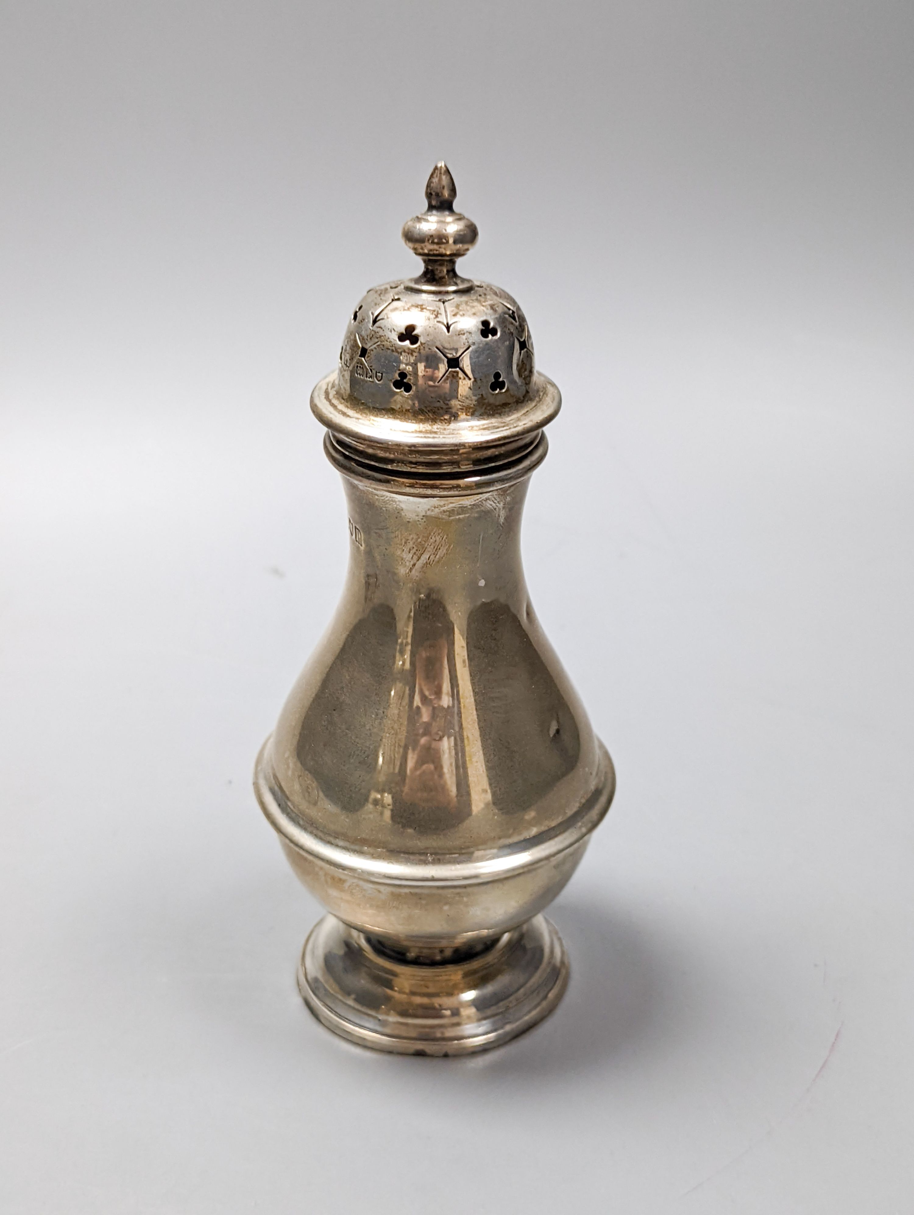 A George V silver sugar caster, London, 1910, 16.6cm and a small silver five bar toastrack, 8oz.